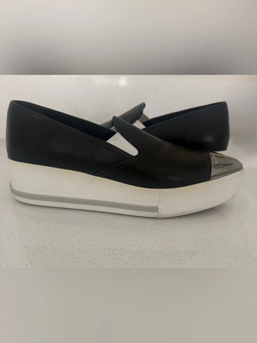Miu Miu Black Leather Slip-On Sneakers with Silver Cap Toe